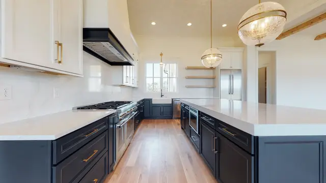 Naval base cabinets flanking the range under a dark hood