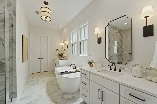 Oyster vanity with a freestanding tub and marble floor
