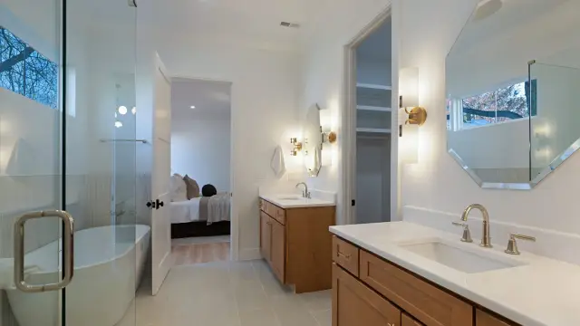 Sand vanity in a primary bath suite