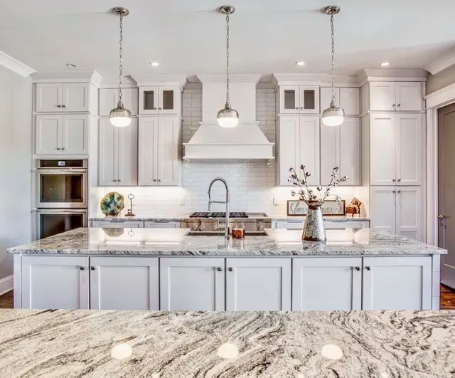 Timberland White cabinetry with a granite island and double ovens