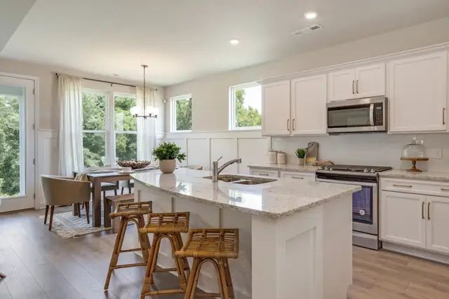 Timberland White kitchen with a granite island and breakfast nook