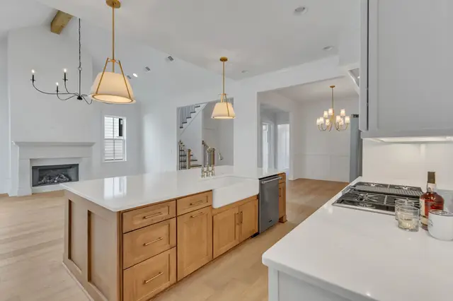 Open-plan Timberland White kitchen with a Sand island